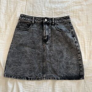Distressed black denim skirt